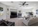 Cozy living room featuring a fireplace, entertainment center, and an abundance of natural light at 8290 Gagnier Blvd, Las Vegas, NV 89113