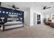 Expansive main bedroom with a blue accent wall, plush carpet, and ample space for a seating area at 8290 Gagnier Blvd, Las Vegas, NV 89113
