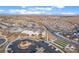 An aerial view captures a community with a pool, bocce ball, and pickleball courts, against a mountain backdrop at 905 Belleforte Ln, Las Vegas, NV 89138