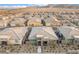 Expansive aerial view of a single-Gathering home with a landscaped backyard and desert landscape at 905 Belleforte Ln, Las Vegas, NV 89138