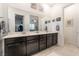 Bathroom featuring double vanity with dark cabinets, large mirror and tile floor at 905 Belleforte Ln, Las Vegas, NV 89138