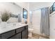 Well-lit bathroom with a tub/shower, modern vanity, framed mirror, and stylish tile flooring at 905 Belleforte Ln, Las Vegas, NV 89138