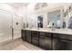 Luxurious bathroom with dual sinks, framed mirrors, a glass-enclosed shower, and ample counter space at 905 Belleforte Ln, Las Vegas, NV 89138