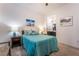Comfortable bedroom featuring soft carpet, teal bedding, and unique side table lamps at 905 Belleforte Ln, Las Vegas, NV 89138