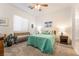 Serene bedroom featuring light teal bedding, a ceiling fan, a wooden bench and carpeted floors at 905 Belleforte Ln, Las Vegas, NV 89138
