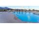 Enjoy the community pool with lounge chairs, covered seating, and mountain views at 905 Belleforte Ln, Las Vegas, NV 89138