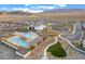 A community pool and clubhouse offer recreation, with mountains in the background and well-maintained surroundings at 905 Belleforte Ln, Las Vegas, NV 89138