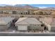 Single-Gathering home with a two-car garage, desert landscaping, and mountain views at 905 Belleforte Ln, Las Vegas, NV 89138