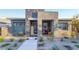 Charming single-story home with a stone accent wall and manicured desert landscaping at 905 Belleforte Ln, Las Vegas, NV 89138