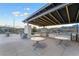 Outdoor grill station with stainless steel appliances, seating, and covered lighting for evening cookouts at 905 Belleforte Ln, Las Vegas, NV 89138