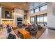 Spacious lounge area with sofas, chairs, fireplace and a panoramic view at 905 Belleforte Ln, Las Vegas, NV 89138