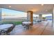 Beautiful outdoor patio with scenic views, stone pillars, and ample seating for entertaining guests at 905 Belleforte Ln, Las Vegas, NV 89138