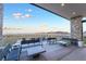 Open-air patio boasting comfortable seating, stone accents, and picturesque views of the surrounding landscape at 905 Belleforte Ln, Las Vegas, NV 89138