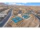 An aerial shot of pickleball courts in a community setting with views of the city and mountains at 905 Belleforte Ln, Las Vegas, NV 89138