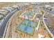 Aerial view of pickleball courts in a modern community with meticulously landscaped surroundings at 905 Belleforte Ln, Las Vegas, NV 89138