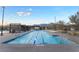 Large swimming pool with lap lanes, shade structures and mountain views for community enjoyment at 905 Belleforte Ln, Las Vegas, NV 89138