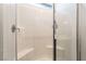 Bright shower with white subway tile, built-in seat, and glass door at 905 Belleforte Ln, Las Vegas, NV 89138