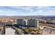 Bright aerial view of two high-rise towers, showcasing a wide surrounding landscape with palm trees and blue skies at 9103 Alta Dr # 102, Las Vegas, NV 89145