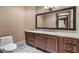 Elegant bathroom features a spacious vanity with a cream countertop and beautiful mirror at 9103 Alta Dr # 102, Las Vegas, NV 89145