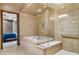 Luxurious bathroom featuring a tub, glass shower, and tiled walls, creating a spa-like experience at 9103 Alta Dr # 102, Las Vegas, NV 89145