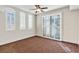 Bright bedroom featuring large windows, plantation shutters, and neutral-toned carpet at 9103 Alta Dr # 102, Las Vegas, NV 89145