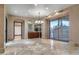 Spacious dining room featuring marble floors, bar area, large windows and modern chandelier at 9103 Alta Dr # 102, Las Vegas, NV 89145