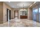 Elegant dining room with chandelier, wet bar and access to an outdoor balcony at 9103 Alta Dr # 102, Las Vegas, NV 89145