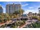 Elegant entrance with lush landscaping, featuring palm trees and a secure, gated entry for privacy at 9103 Alta Dr # 102, Las Vegas, NV 89145