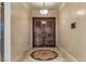 Elegant entryway featuring double doors with decorative hardware and beautiful inlaid floor design at 9103 Alta Dr # 102, Las Vegas, NV 89145