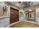 Grand foyer featuring double doors, decorative lighting and intricate tile work on the floor at 9103 Alta Dr # 102, Las Vegas, NV 89145