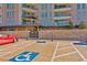 Handicap parking spots in front of a luxury high-rise building with an ornate gated entrance and covered walkways at 9103 Alta Dr # 102, Las Vegas, NV 89145