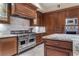Beautiful kitchen featuring granite counters, stainless appliances, and custom wood cabinets at 9103 Alta Dr # 102, Las Vegas, NV 89145
