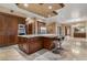Chef's kitchen boasts granite island, breakfast bar, stainless appliances, and custom cabinetry at 9103 Alta Dr # 102, Las Vegas, NV 89145