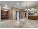Open living room with marble floors, bar area, and double door entryway, perfect for entertaining at 9103 Alta Dr # 102, Las Vegas, NV 89145