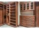 Well-organized walk-in closet featuring open shelving, drawers, and custom wood cabinets at 9103 Alta Dr # 102, Las Vegas, NV 89145