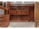 Spacious walk-in closet with custom wood shelving, drawers, and ample storage space at 9103 Alta Dr # 102, Las Vegas, NV 89145