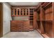 Custom walk-in closet featuring custom wood cabinetry, drawers, and shelving for ample storage at 9103 Alta Dr # 102, Las Vegas, NV 89145