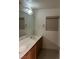 Bathroom features dual sinks, a large mirror, and a vanity with wood cabinets at , Las Vegas, NV 89148
