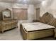 Spacious bedroom boasts an ornate bed frame and matching dresser with mirror at , Las Vegas, NV 89148