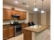 Kitchen with wood cabinets, stainless steel appliances, and center island with sink at , Las Vegas, NV 89148