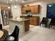 Spacious kitchen with wood cabinetry, stainless appliances, and an island with seating at , Las Vegas, NV 89148