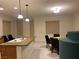 Kitchen with island, stainless steel sink, wood cabinets, and adjacent dining area at , Las Vegas, NV 89148