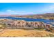 Community aerial view showcasing the lake, residential buildings, and landscaping at 1 Corte Belleza, Henderson, NV 89011