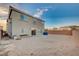 The rear exterior shows backyard, the home's back windows and door, and a view of the sky at 10306 Coastline Creek Ct, Las Vegas, NV 89141
