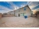 Rear exterior shows backyard with retaining wall, and the home's back windows and door at 10306 Coastline Creek Ct, Las Vegas, NV 89141