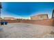 Backyard with perimeter wall ready for your landscaping design, with neighboring houses visible at 10306 Coastline Creek Ct, Las Vegas, NV 89141