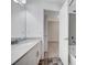 Bathroom featuring a single sink with white countertop, white cabinets, tiled floors, and a shower with tub at 10306 Coastline Creek Ct, Las Vegas, NV 89141