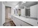 Bathroom featuring double sinks with white countertops, white cabinets, and tiled floors for a clean and modern aesthetic at 10306 Coastline Creek Ct, Las Vegas, NV 89141