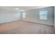Spacious bonus room with neutral carpeting and plenty of natural light at 10306 Coastline Creek Ct, Las Vegas, NV 89141