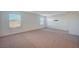 Large bonus room featuring neutral carpeting and multiple windows for natural light at 10306 Coastline Creek Ct, Las Vegas, NV 89141